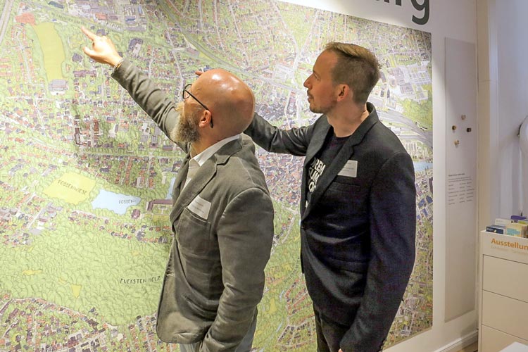 Illustrator Detlef Krause (links) und Computergrafiker Thiemo Eddiks vor ihrem überdimensionalen, detailgetreuen Oldenburg-Stadtplan in 3D-Optik.