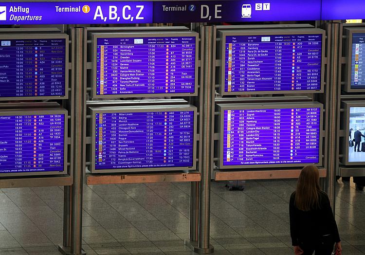 Frau vor Informationstafel am Frankfurter Flughafen, über dts Nachrichtenagentur